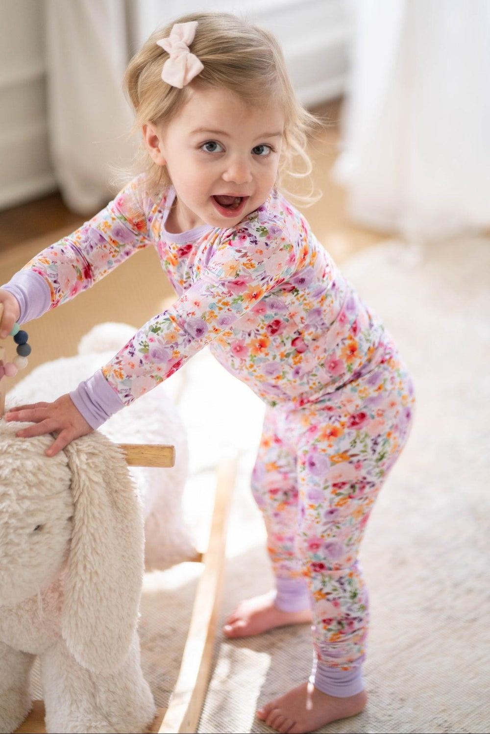 Front view of child in long sleeve floral bamboo pajama set, soft and breathable for year-round comfort.