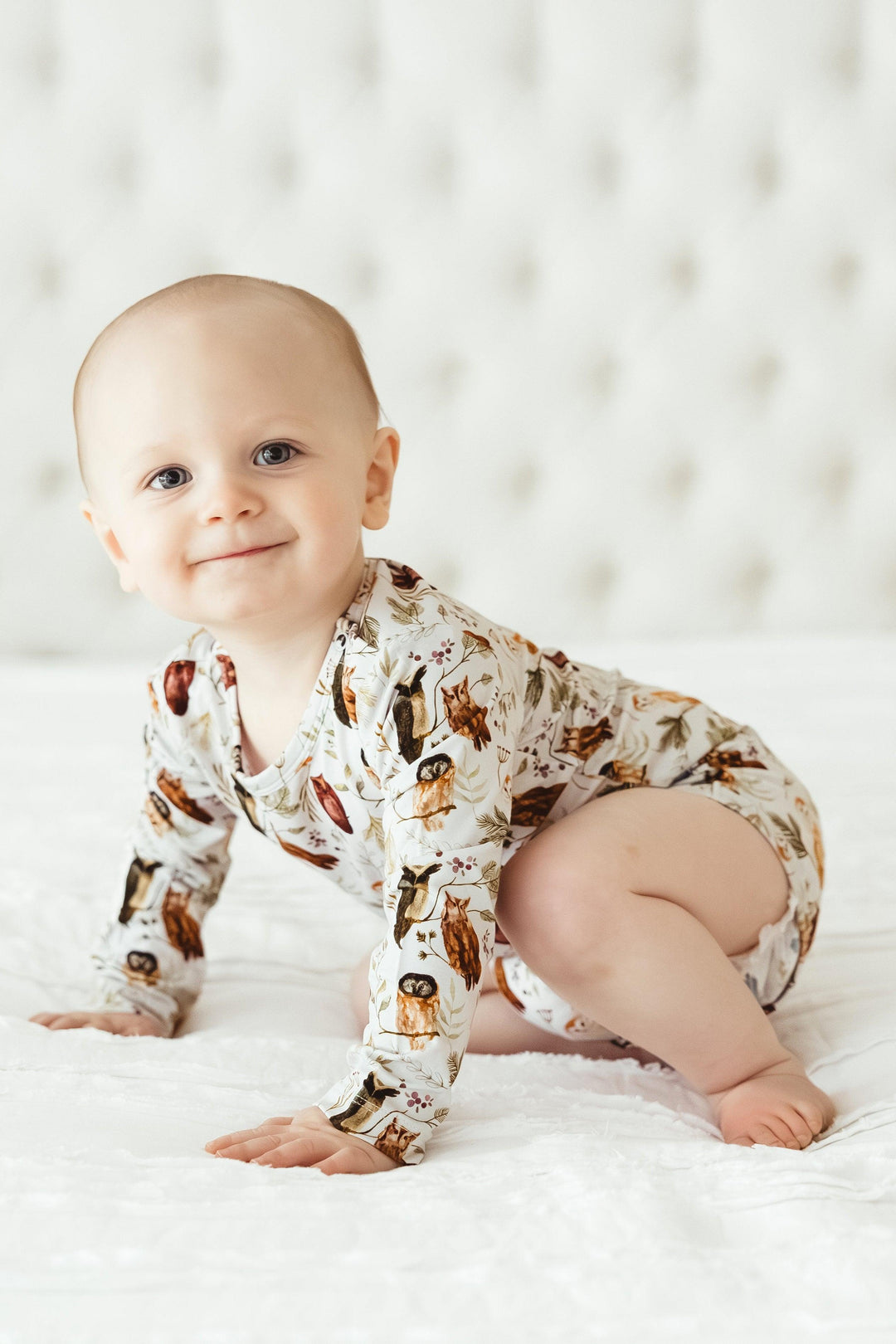 Baby crawling in long sleeve Sleepy Hollow Owls bamboo bodysuit, showing flexible, breathable fit and cozy woodland style.
