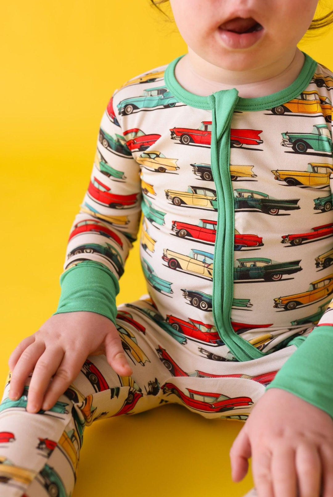Close-up of retro car print on classic cars bamboo zipper pajamas, showcasing the fun and colorful vehicle pattern on breathable fabric.