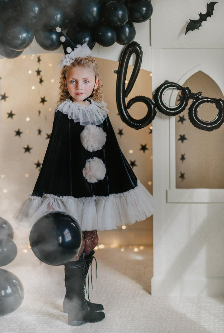 Whimsical pirouette clown Halloween outfit for toddler girl holding balloon