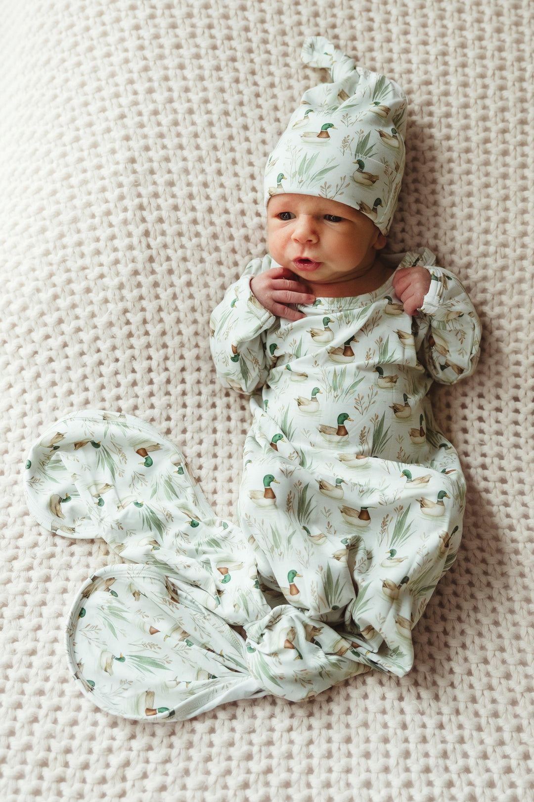 Newborn baby wearing Mallard Ducks long sleeve bamboo knotted gown, lying peacefully in breathable, buttery soft fabric — designed for comfort, easy diaper changes, and adorable first photos.