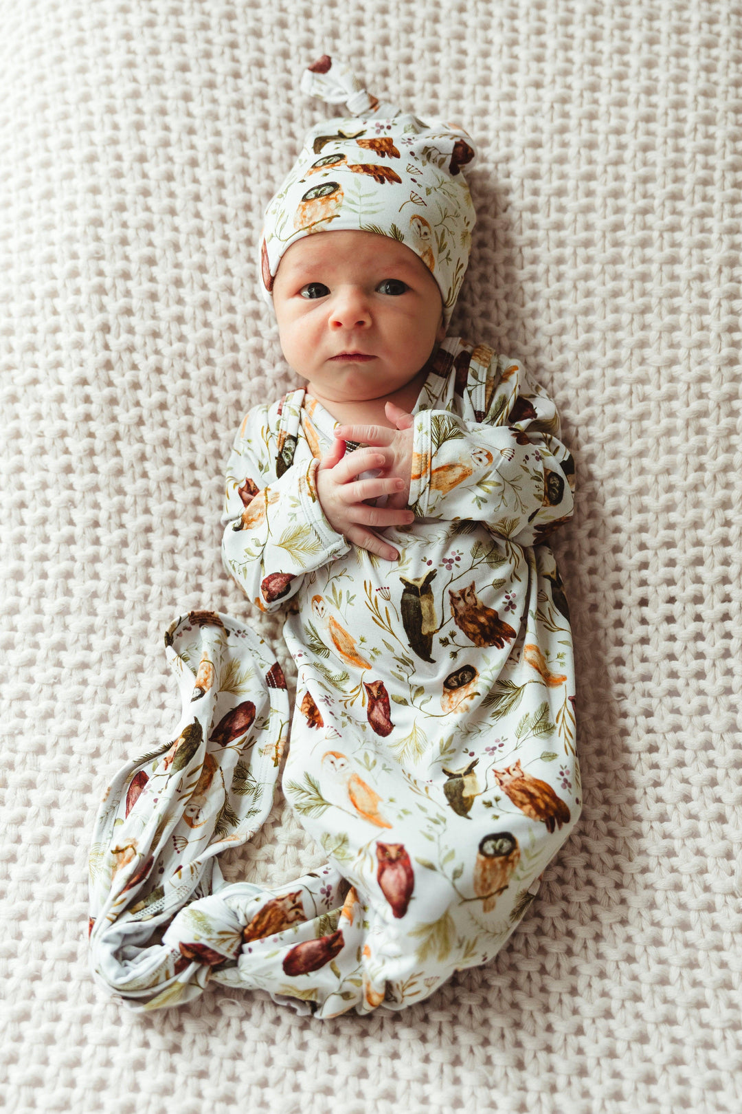 Newborn baby wearing Sleepy Hollow Owls bamboo knotted gown, peacefully lying down in soft, breathable owl print — unisex style ideal for gifting and everyday wear.