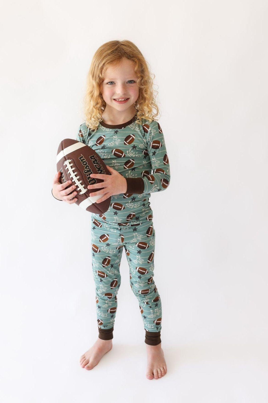 Toddler wearing Football Fans bamboo two-piece pajama set with football print