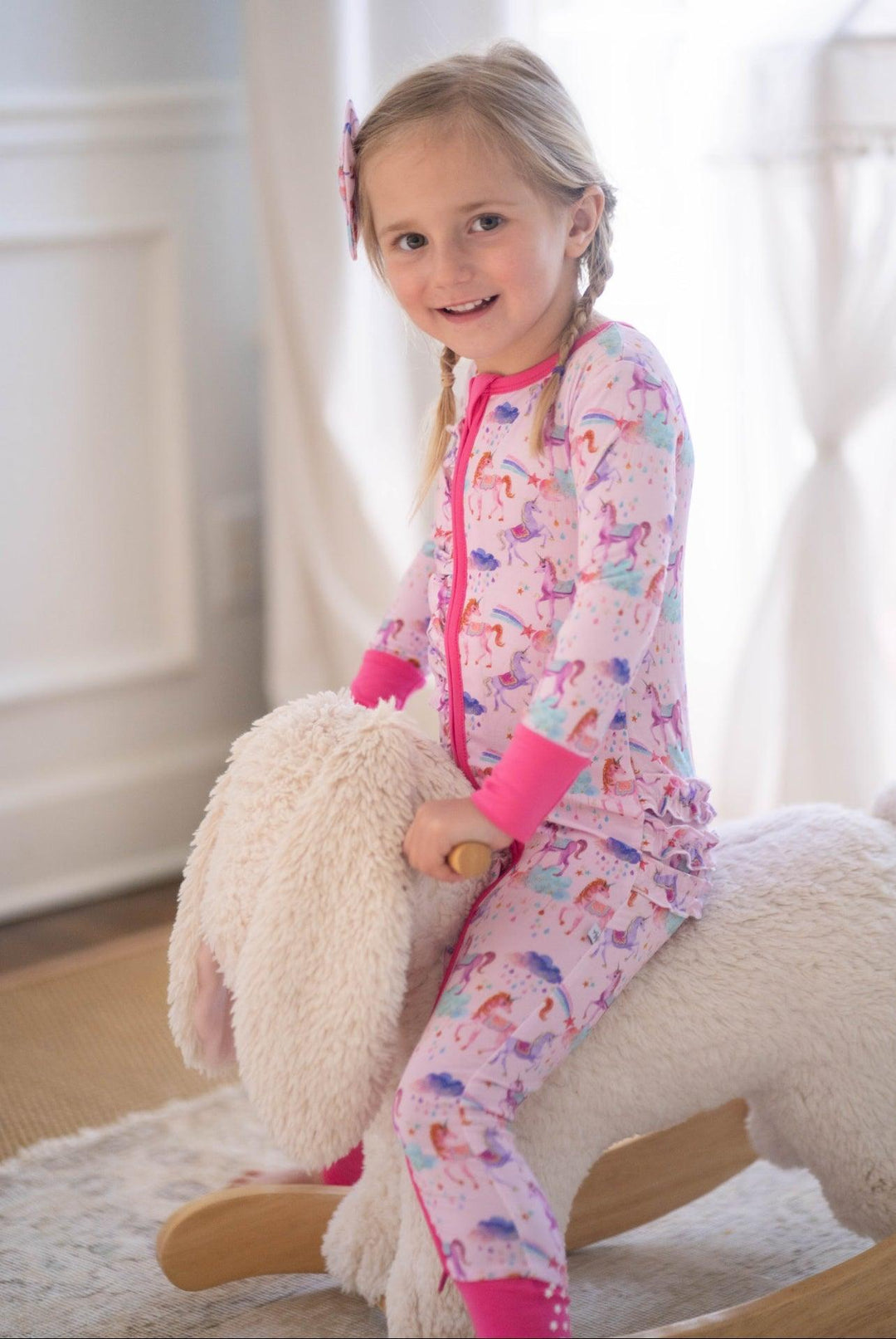 Magical unicorn bamboo zip-up pajamas with pastel rainbow design