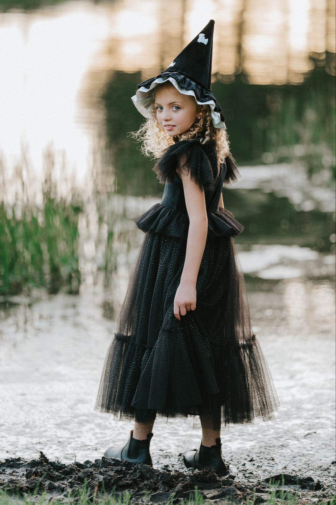 Girls black velvet Halloween witch dress with sparkly tulle layers front view