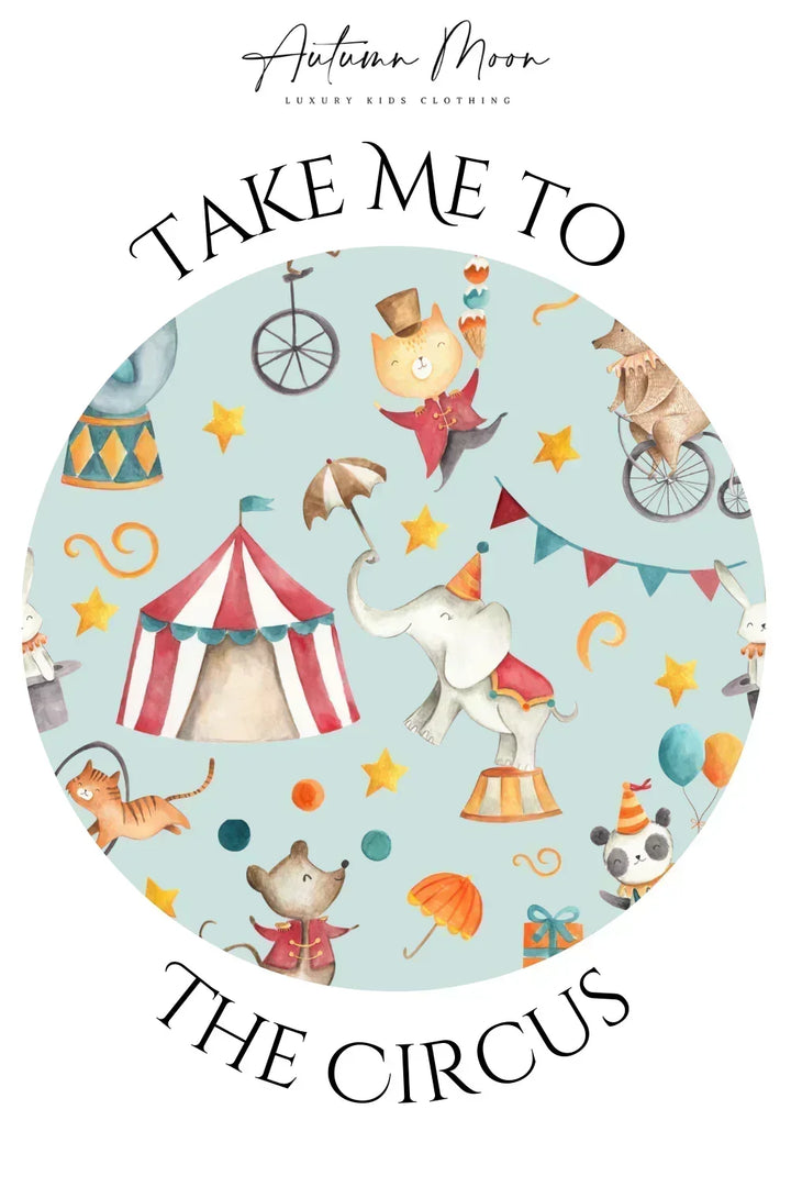 Close-up of circus-themed bamboo fabric featuring animals, tents, balloons, and banners on baby bodysuit.