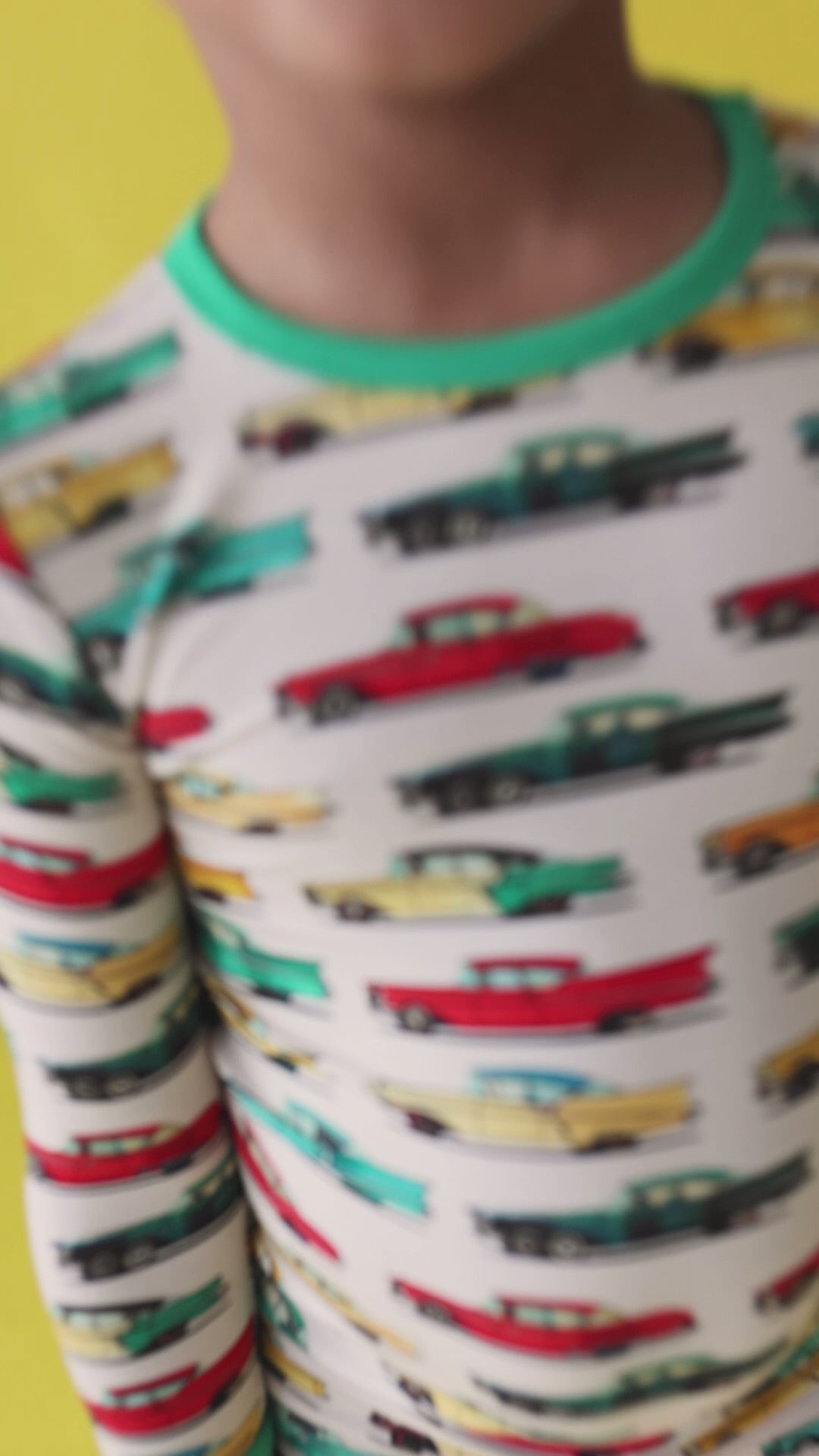 Video of toddler boy wearing classic cars bamboo two-piece pajama set, playing and moving comfortably in lightweight, buttery soft pajamas with vintage car print.