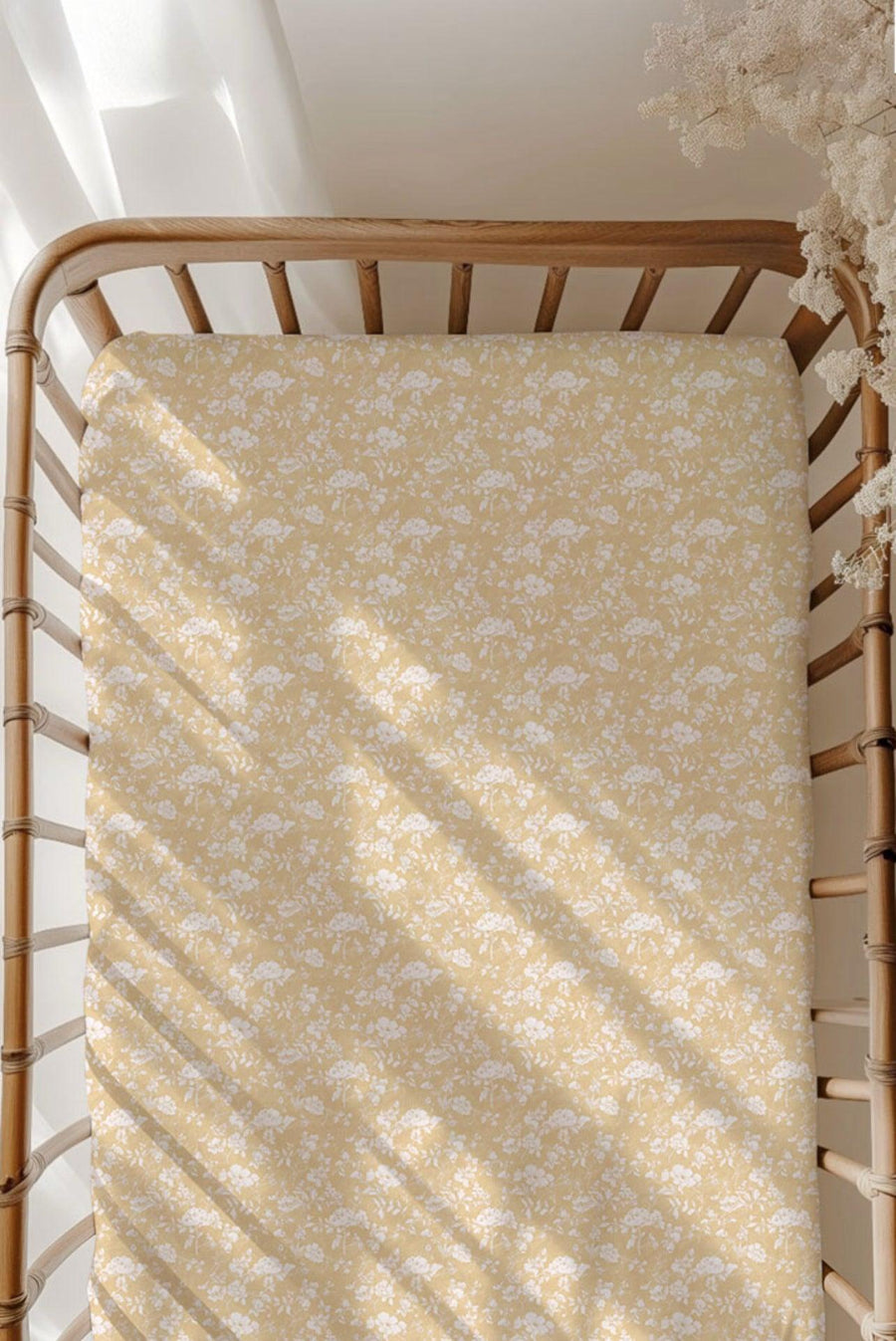 Golden Afternoon bamboo crib sheet on standard crib mattress, featuring a warm golden yellow background with delicate white floral print — ultra-soft, breathable, and perfect for baby girl nurseries.
