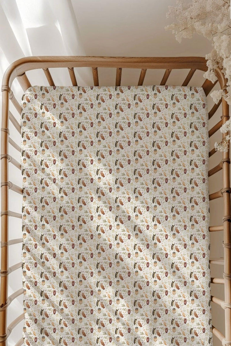 Sleepy Hollow Owls bamboo crib sheet fitted on standard size crib mattress, featuring a soft cream background with baby owl and branch print — cozy, breathable, and perfect for a woodland-themed nursery.
