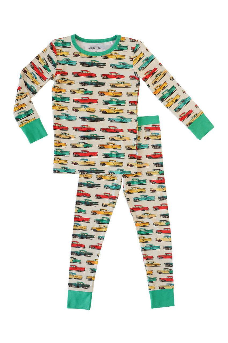 Flat lay of classic cars two-piece bamboo kids pajama set, featuring a soft blue background with colorful retro car print — made from breathable, eco-friendly bamboo fabric.

