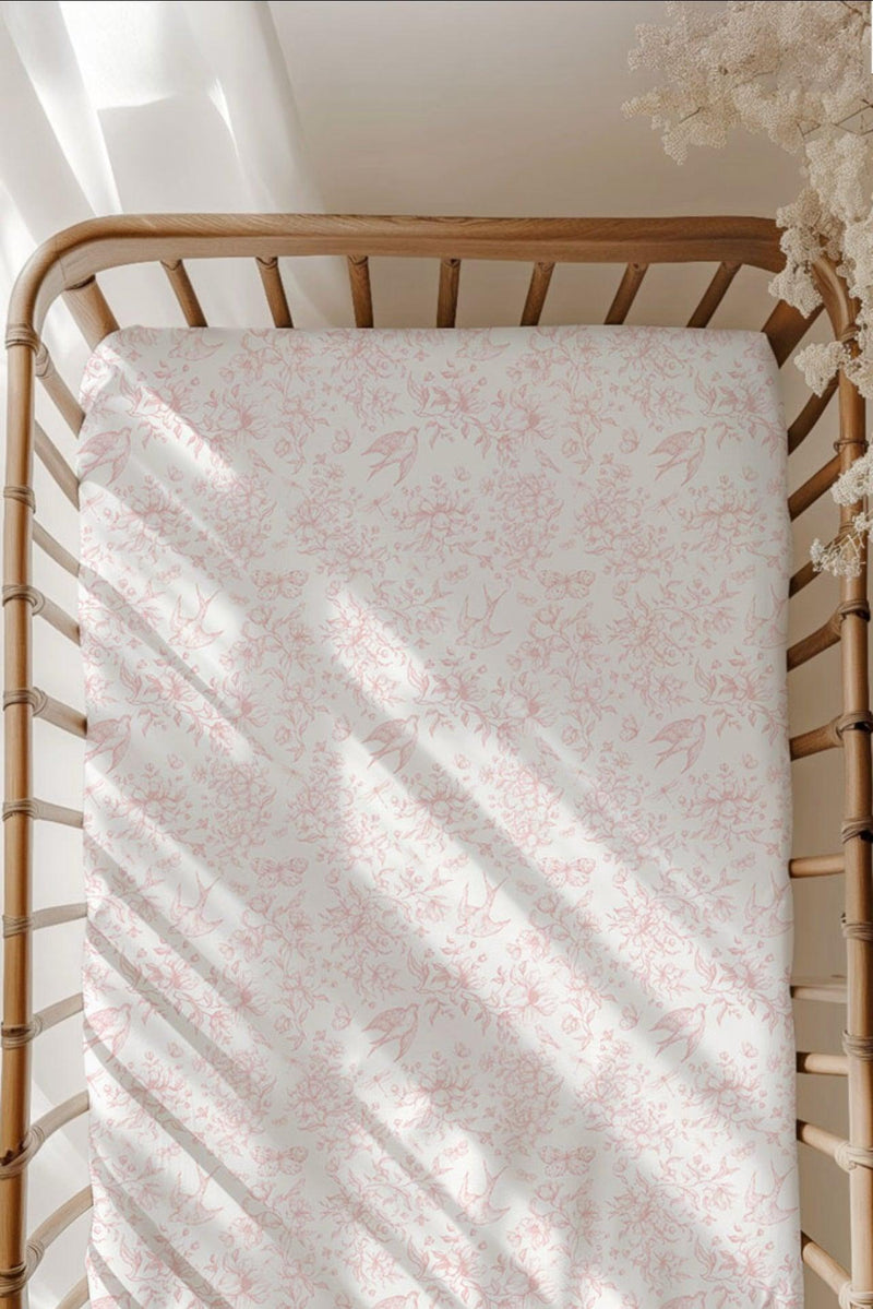 Botanical Lullaby bamboo crib sheet styled on a standard crib mattress, showcasing breathable, ultra-soft fabric with a whimsical floral and bird print — ideal for elegant, unisex nurseries.