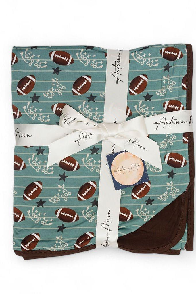 Close-up of double-layer stitching and soft bamboo fabric on football blanket
