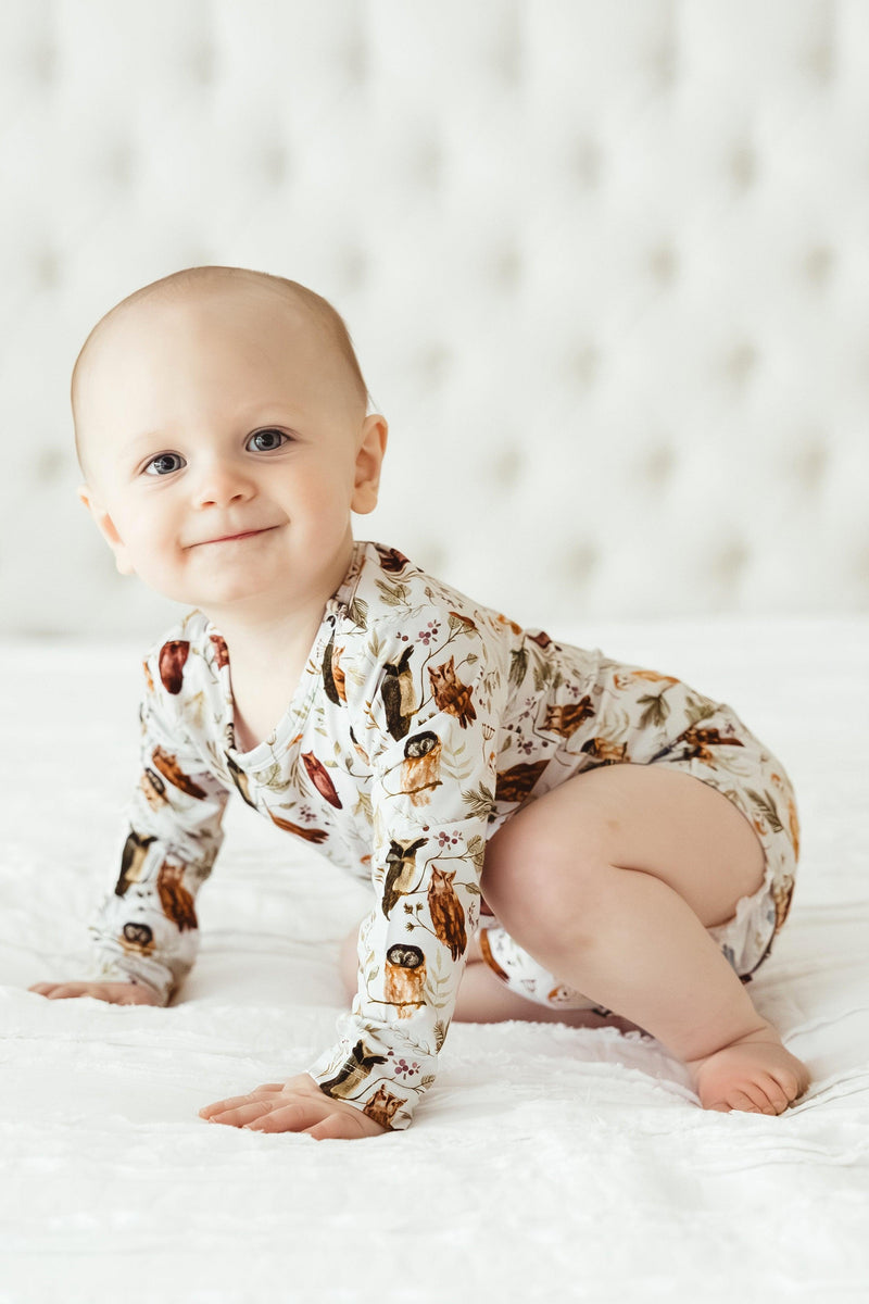 Baby crawling in long sleeve Sleepy Hollow Owls bamboo bodysuit, showing flexible, breathable fit and cozy woodland style.
