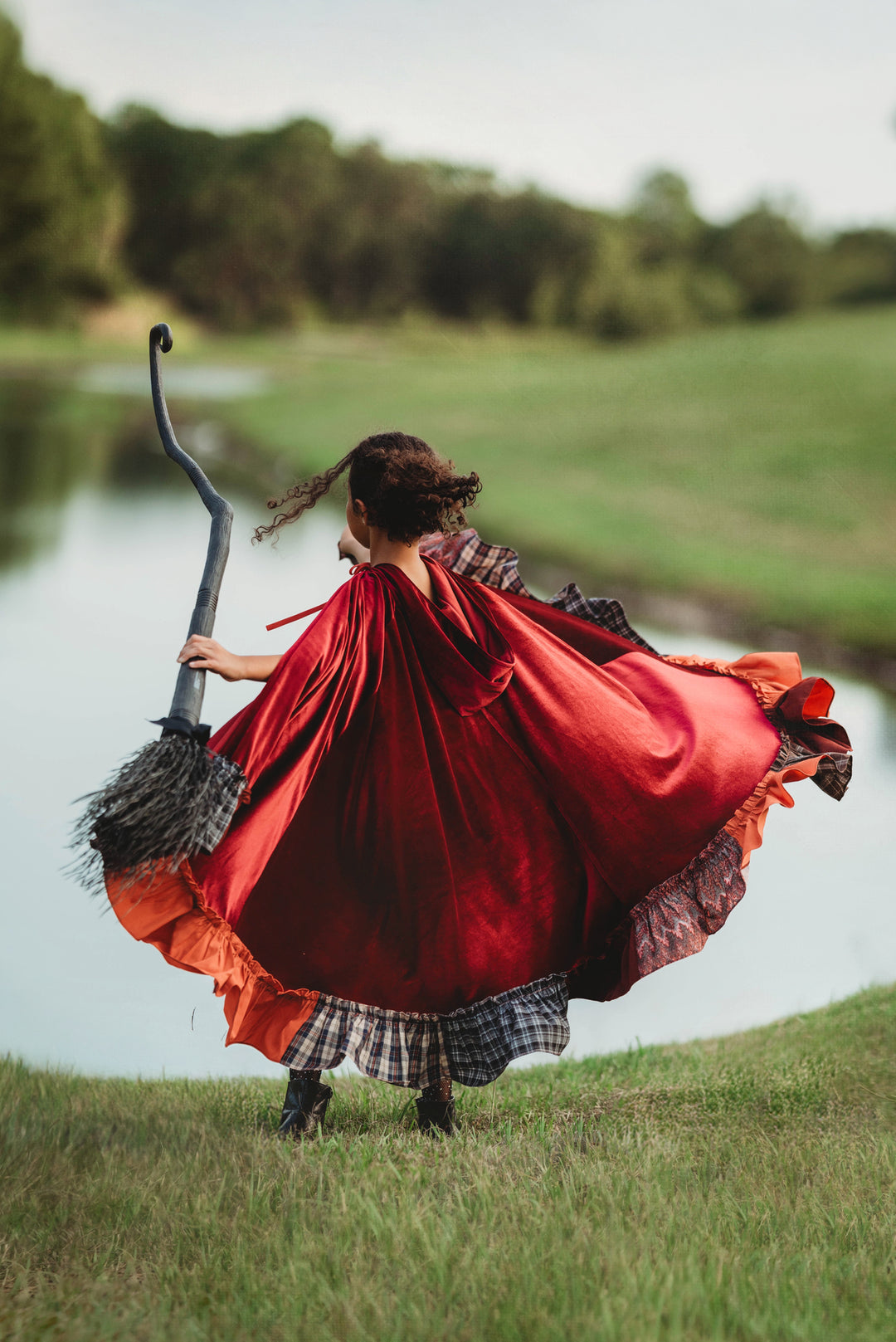 Girl twirling in red velvet witch cape – Hocus Pocus Mary Sanderson Halloween costume