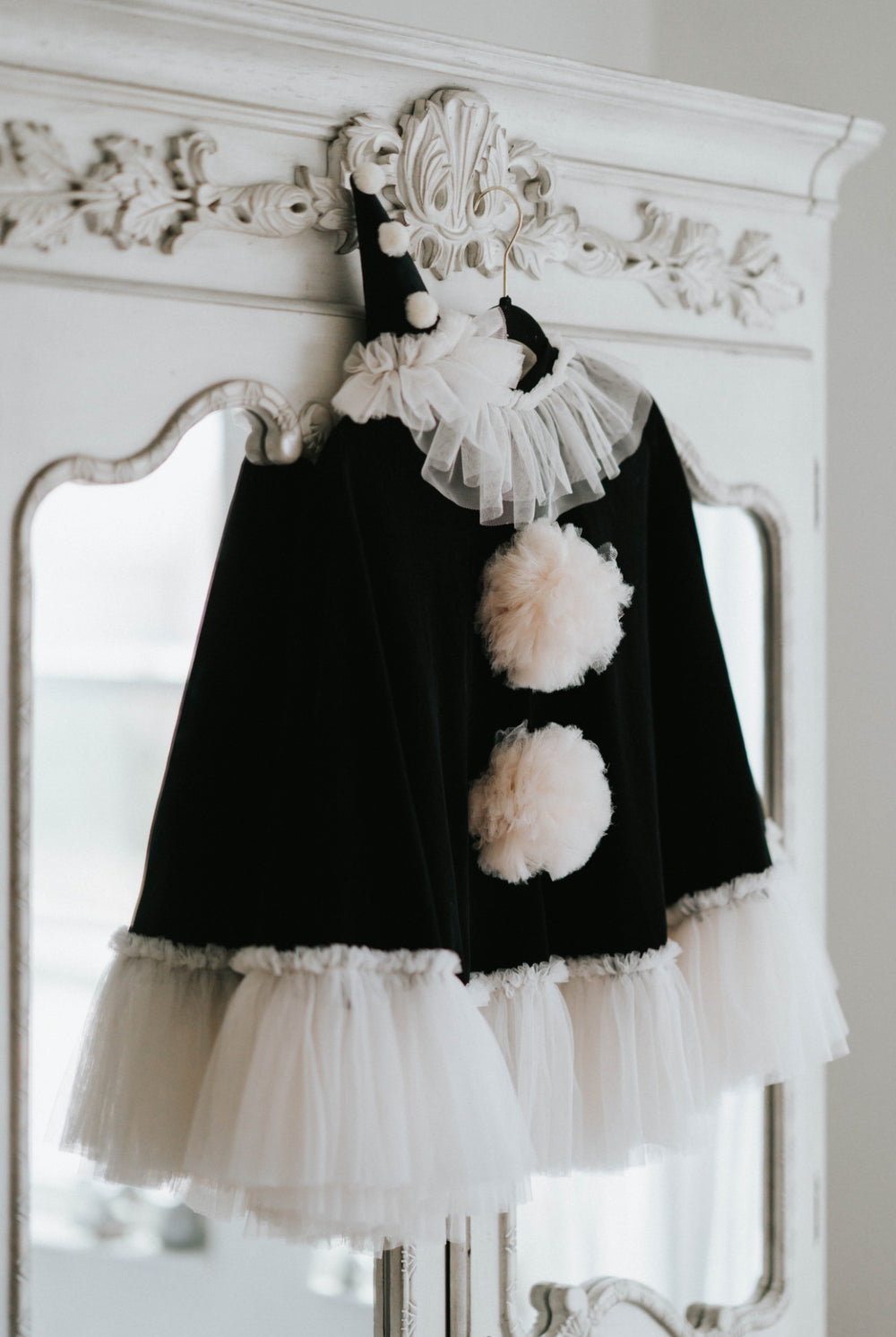 Kids Halloween clown costume with velvet cape and ruffled collar on hanger