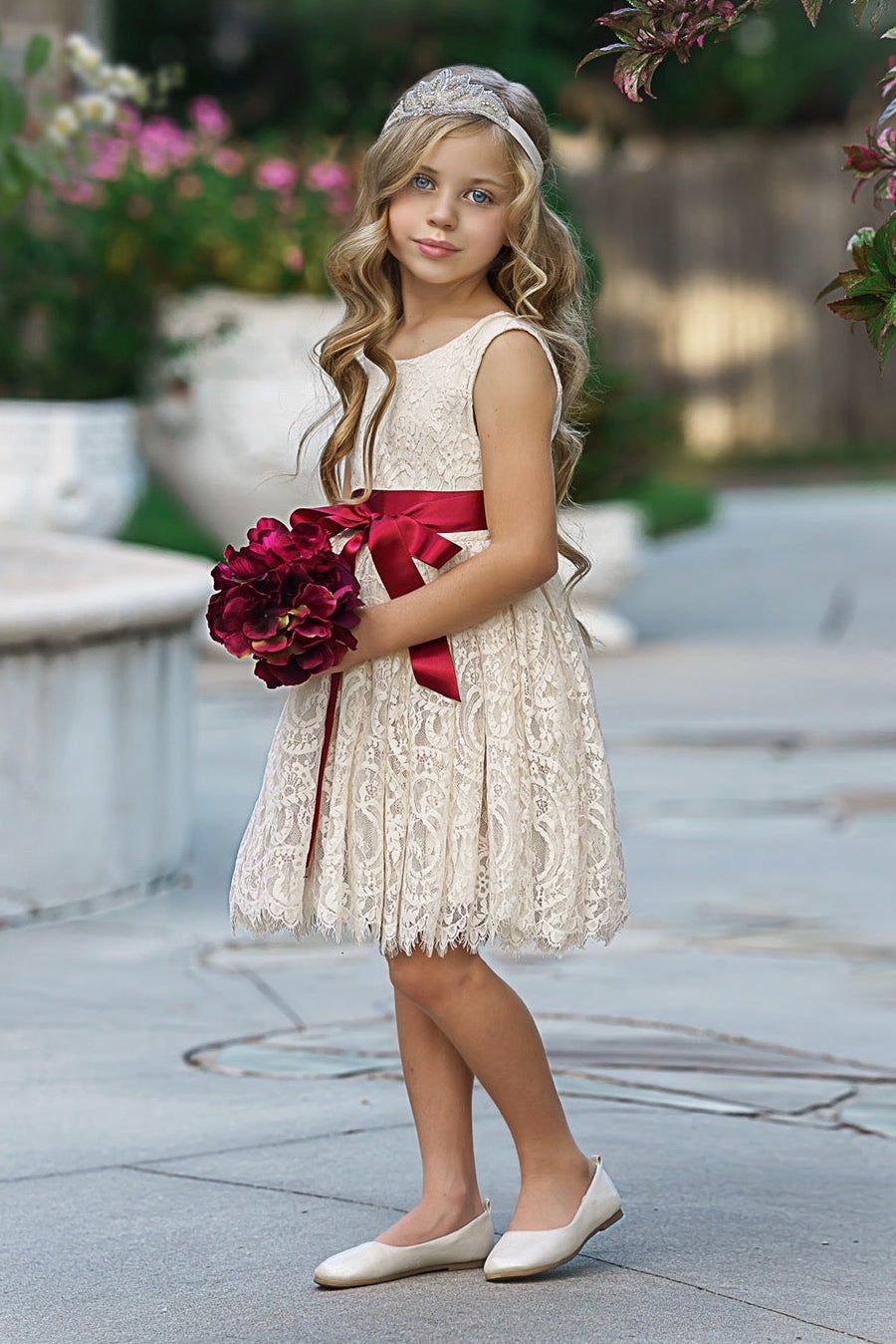 Antique ivory lace flower girl dress front view with knee-length scalloped eyelash hem