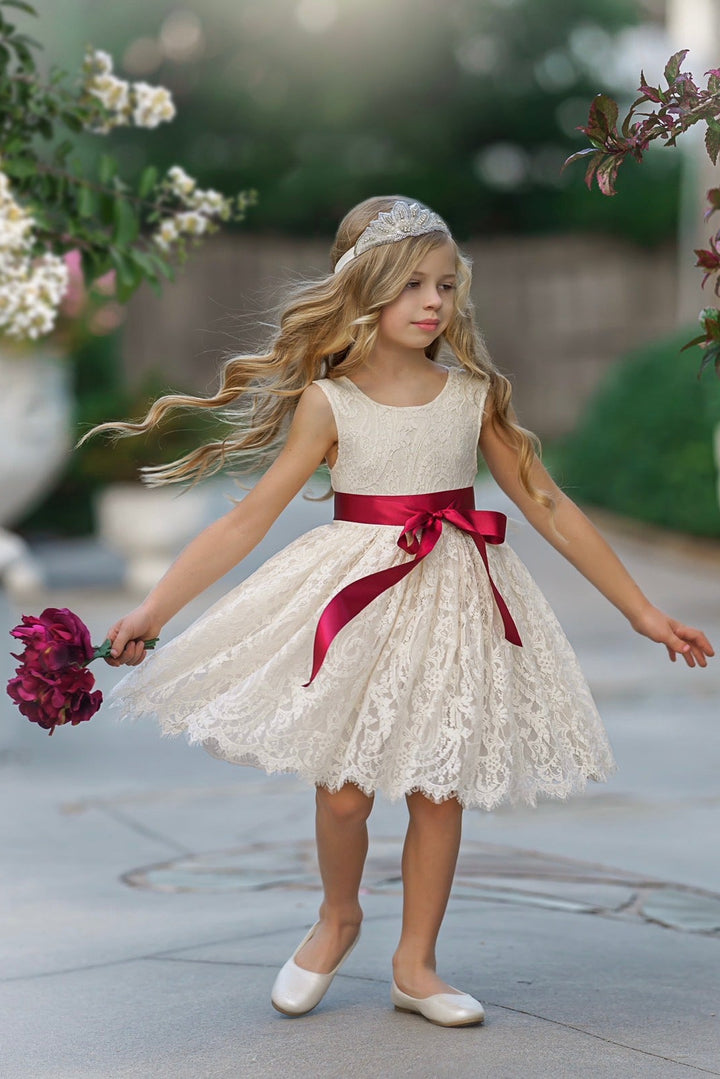 Antique ivory flower girl dress twirl photo showing lace skirt movement and satin sash