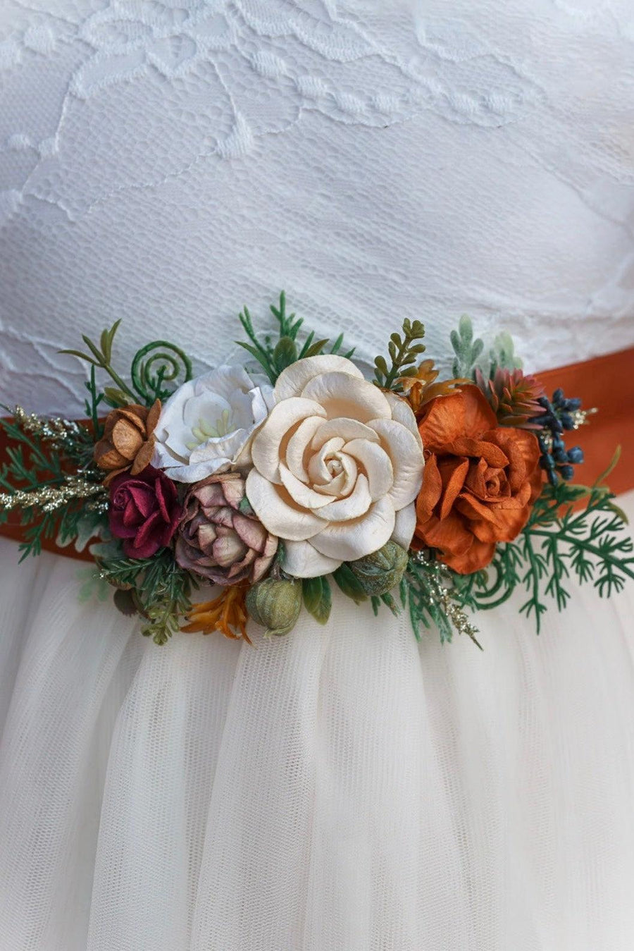 Floral belt with autumn colors on a white dress