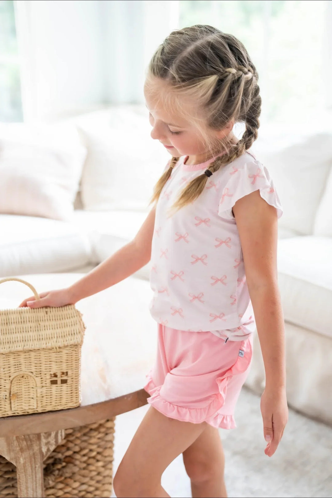Side view of pink bows bamboo girls T-shirt and rose ruffle shorts, breathable and cute warm weather set.