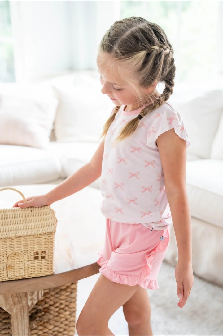 Side view of pink bows bamboo girls T-shirt and rose ruffle shorts, breathable and cute warm weather set.