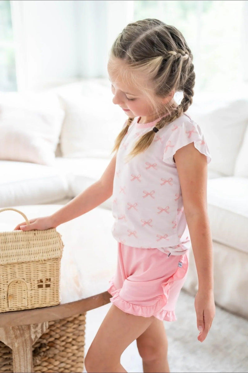 Side view of pink bows bamboo girls T-shirt and rose ruffle shorts, breathable and cute warm weather set.