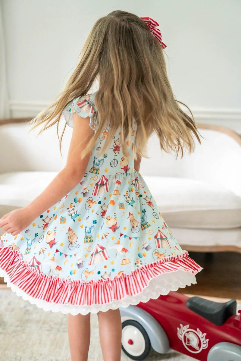 Little girl twirling in Take Me to the Circus ruffle bottom dress, full skirt movement shown in action.