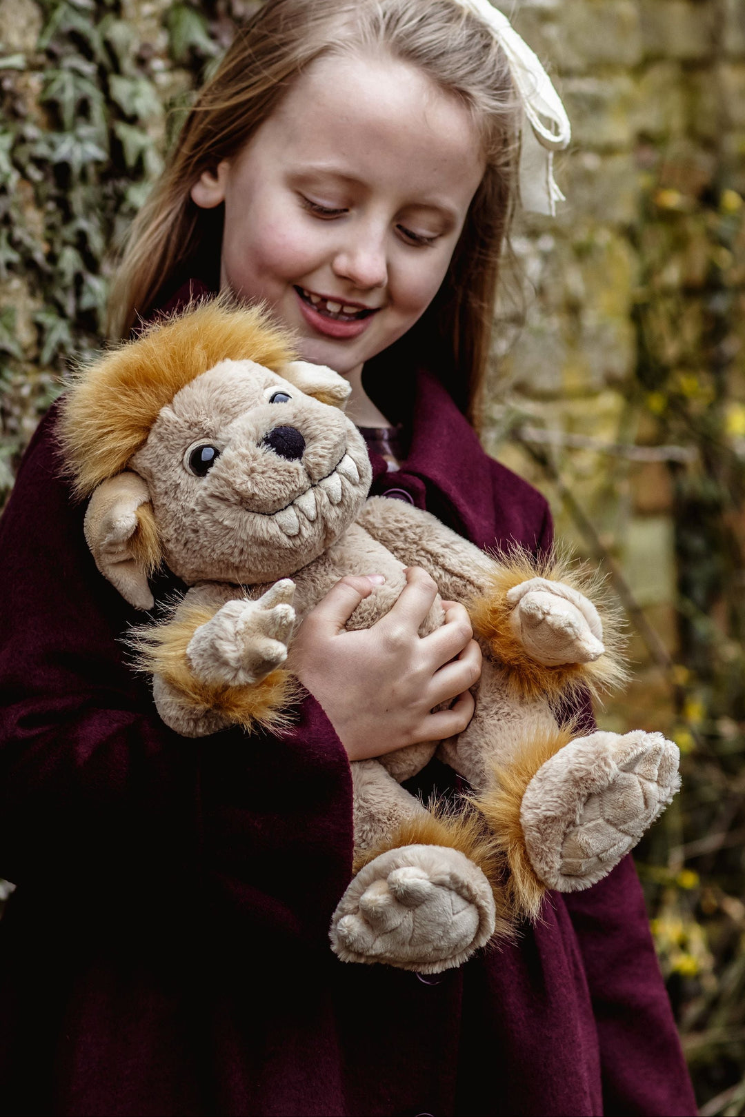 Bedrock ogre plush doll held by child Charlie Bears Bearhouse