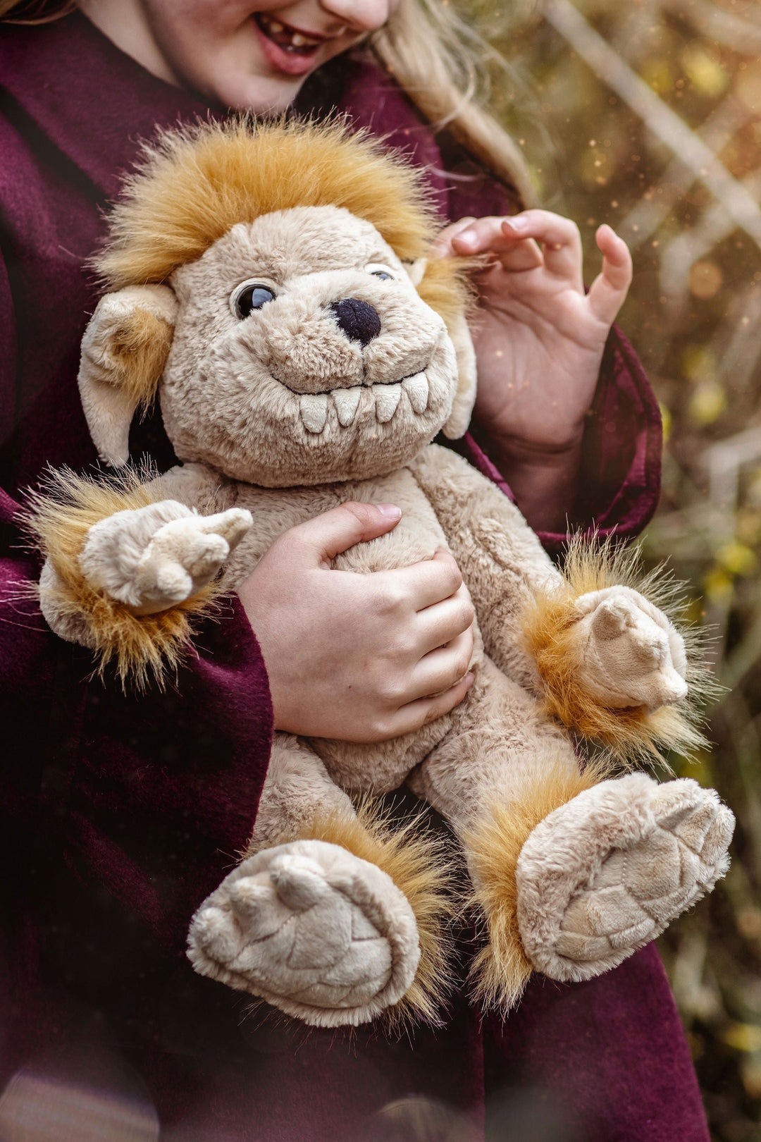 Bedrock plush ogre stuffed animal on rock outdoor lifestyle photo