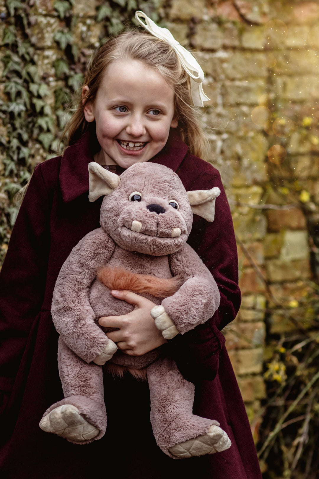Child holding Boulder giant plush Charlie Bears Bearhouse