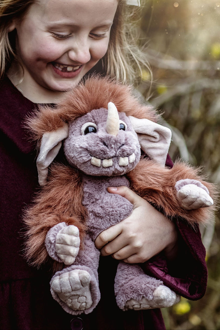 Pebble ogre plush toy sitting on rocks outdoors mythical creature plush Charlie Bears