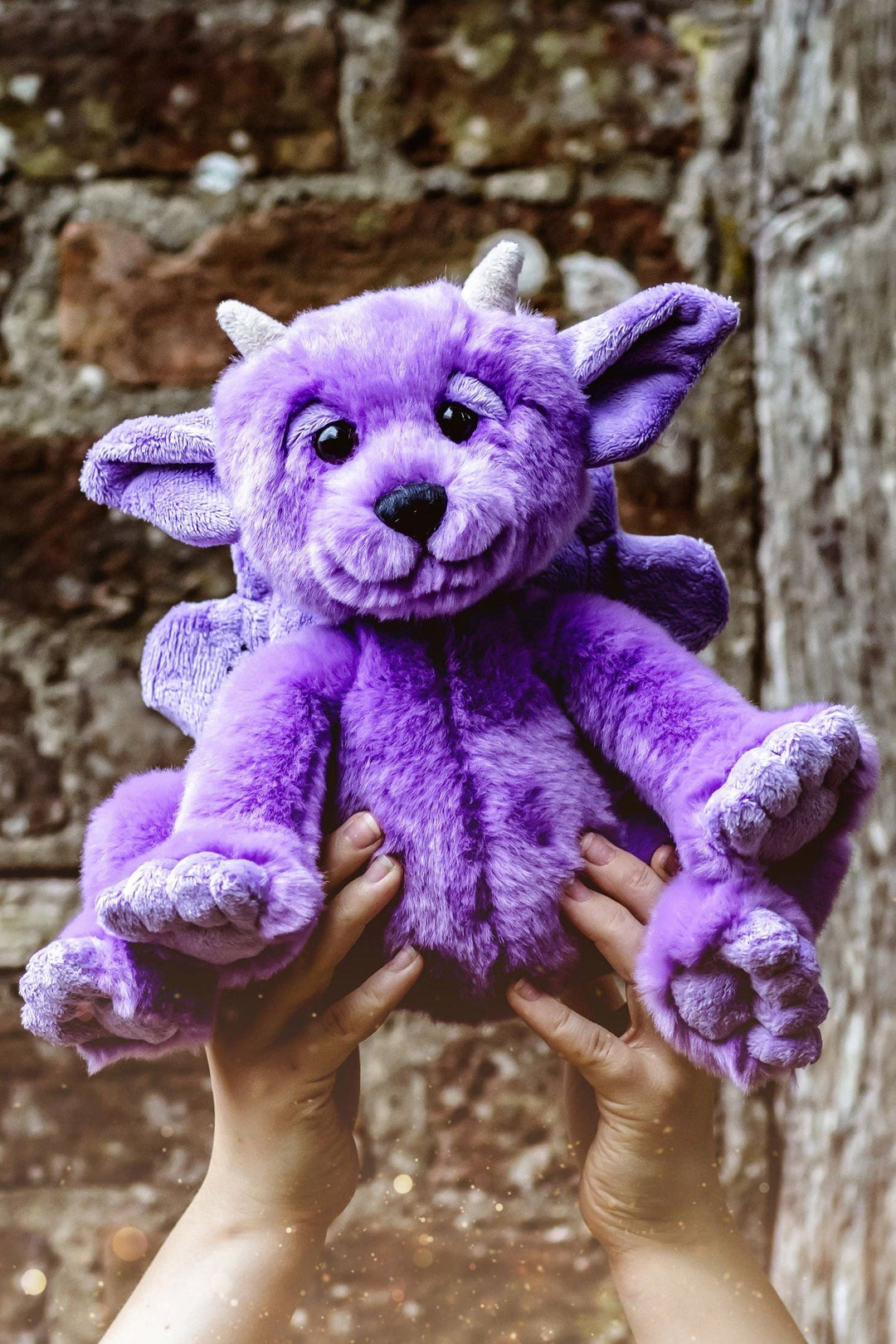 Portcullis purple gargoyle plush by Bearhouse Charlie Bears held up outdoors lifestyle photo
