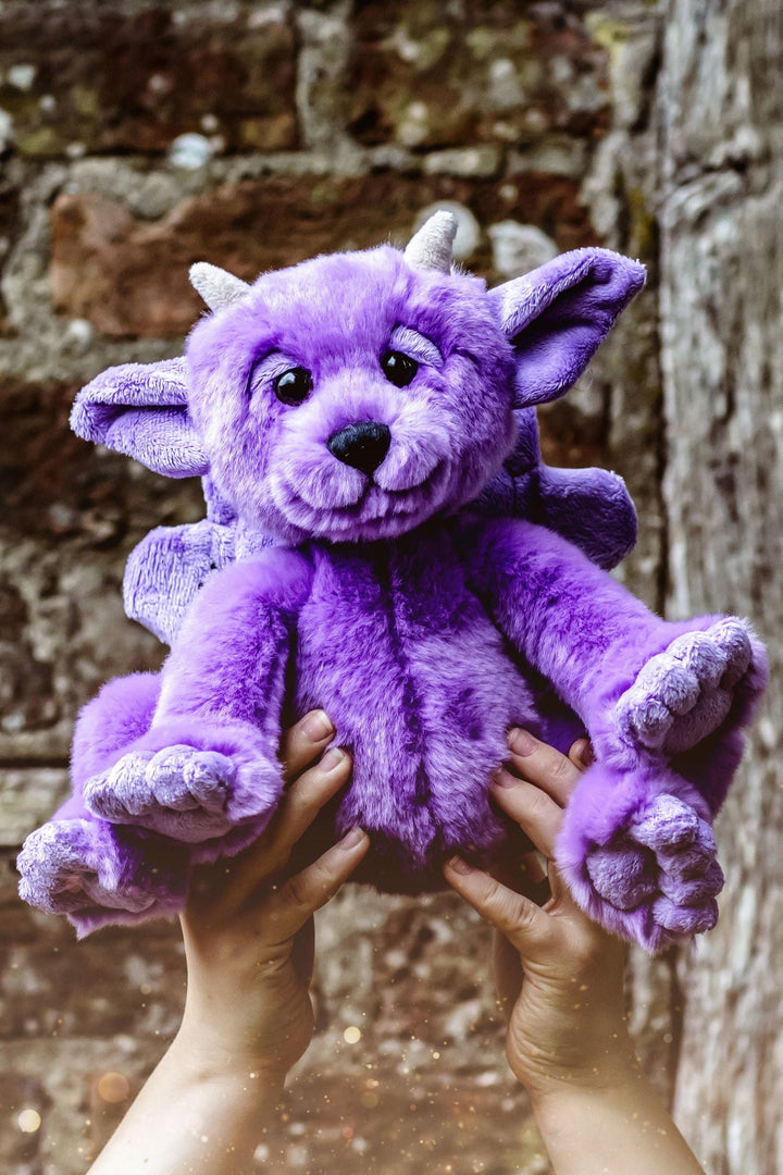 Portcullis purple gargoyle plush by Bearhouse Charlie Bears held up outdoors lifestyle photo