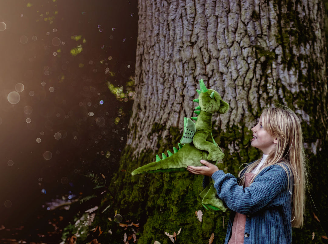 Deck the Dragon plush by Charlie Bears photographed outdoors, highlighting whimsical character design and collector appeal
