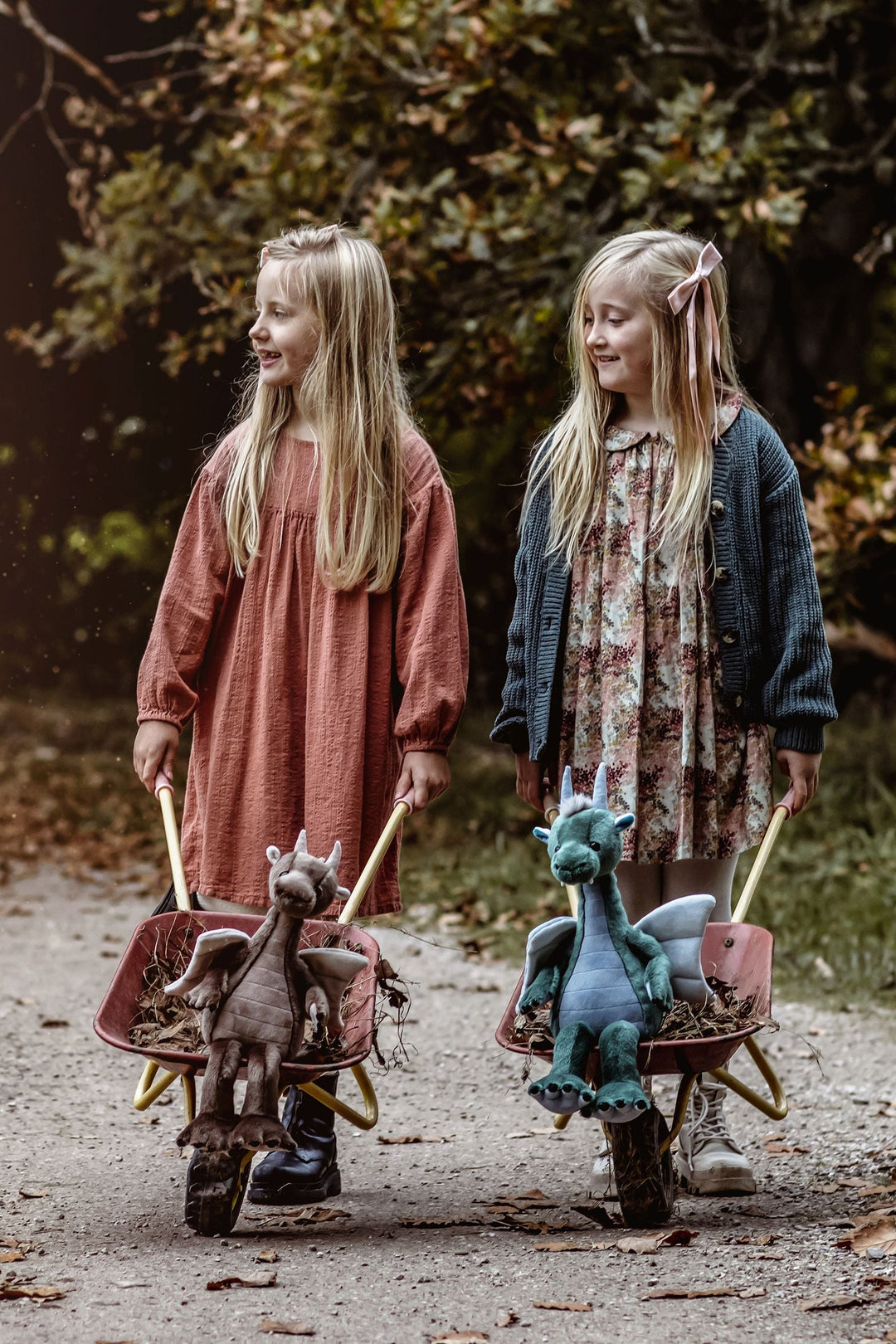 Lifestyle photo of children walking with Bearhouse dragon plush characters, Charlie Bears 2025 collection