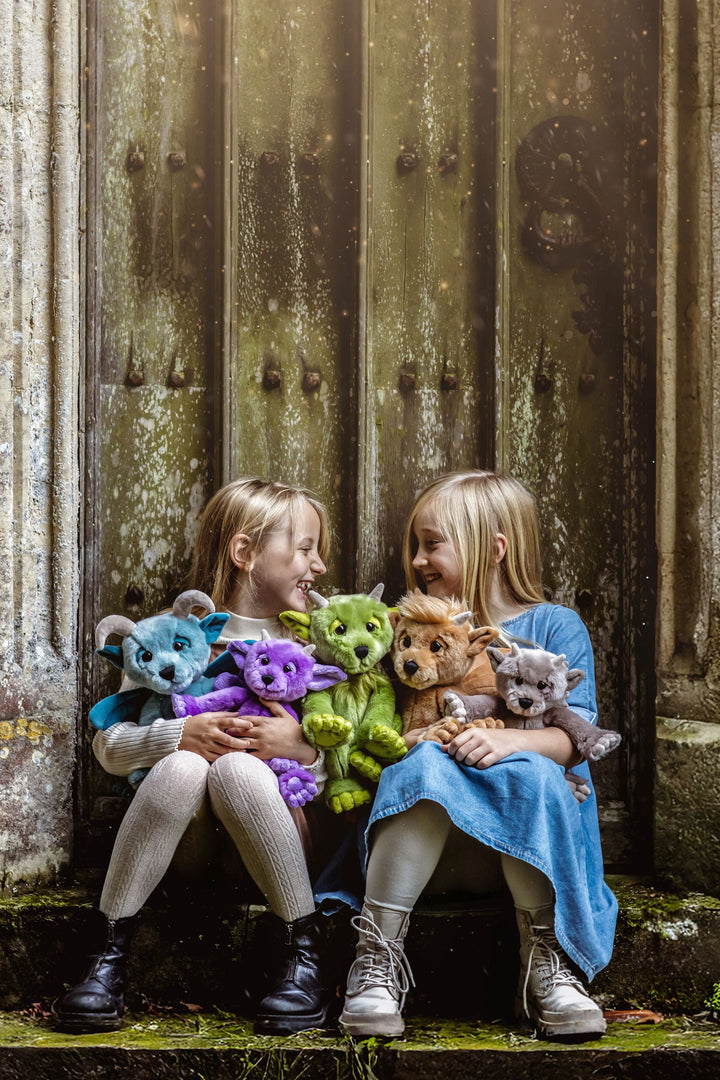 Lifestyle photo of Charlie Bears mythical creature plush toys in storybook setting