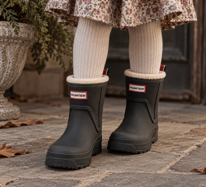 Child wearing black Hunter boots Gracey waterproof rain boots outdoors