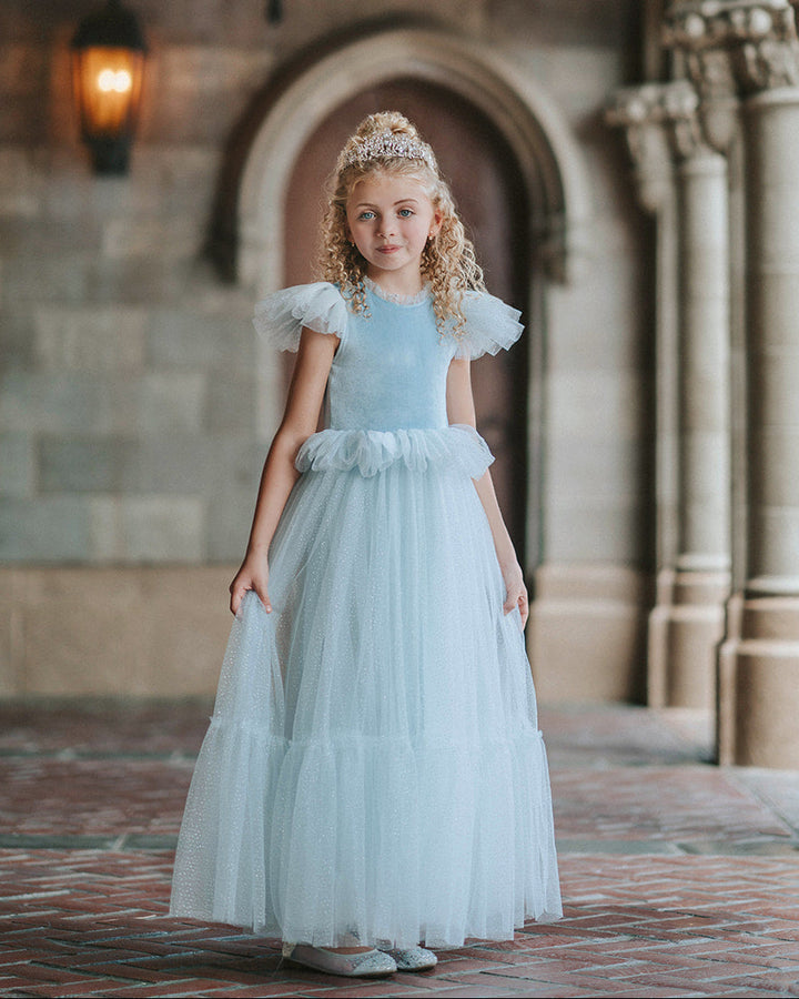 Girl wearing blue velvet princess dress with long sparkle tulle skirt