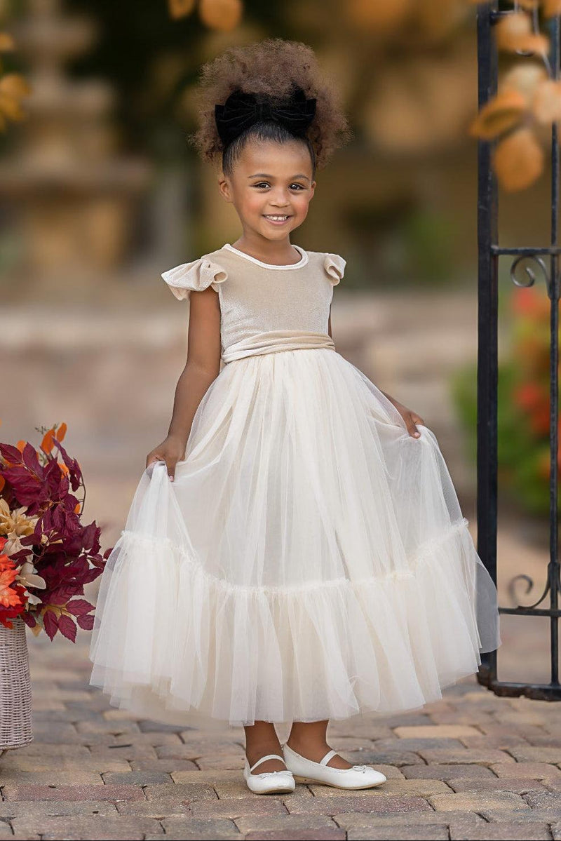 Marcella champagne velvet flower girl dress showing full tulle skirt and warm neutral wedding color