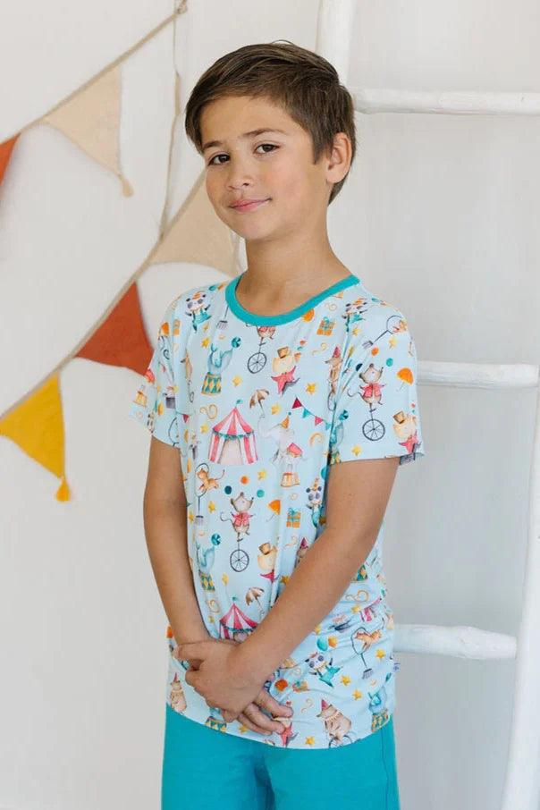 Side view of little boy in Take Me to the Circus unisex bamboo graphic T-shirt, short sleeve summer style.
