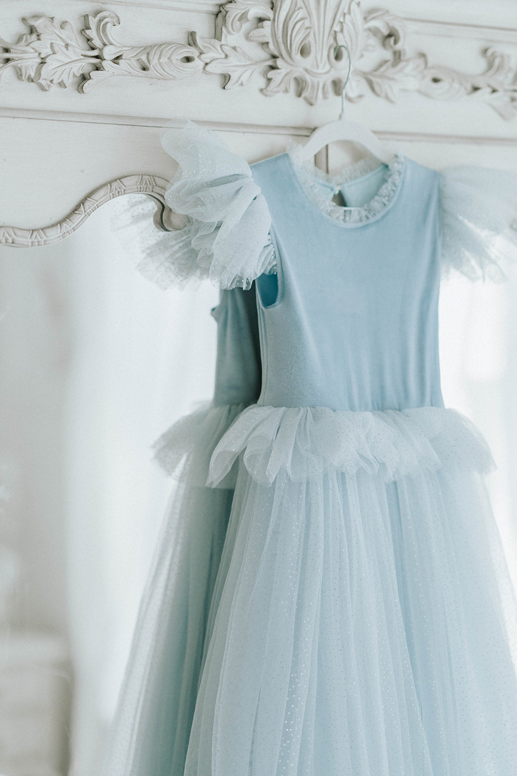 Close-up of blue velvet princess dress with tulle ruffle sleeves and sparkle skirt