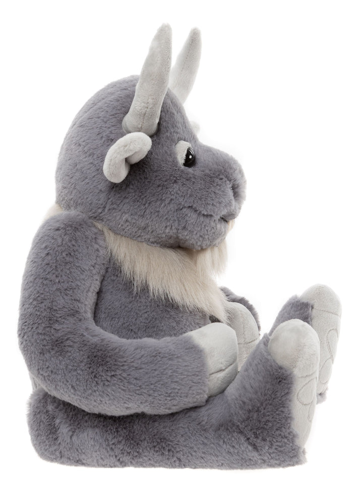 Cobblestone giant plush side view sitting showing curved horns and fluffy beard
