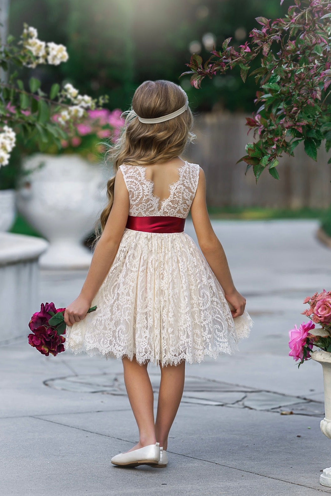 Antique ivory lace flower girl dress with V-back and satin sash, garden wedding style