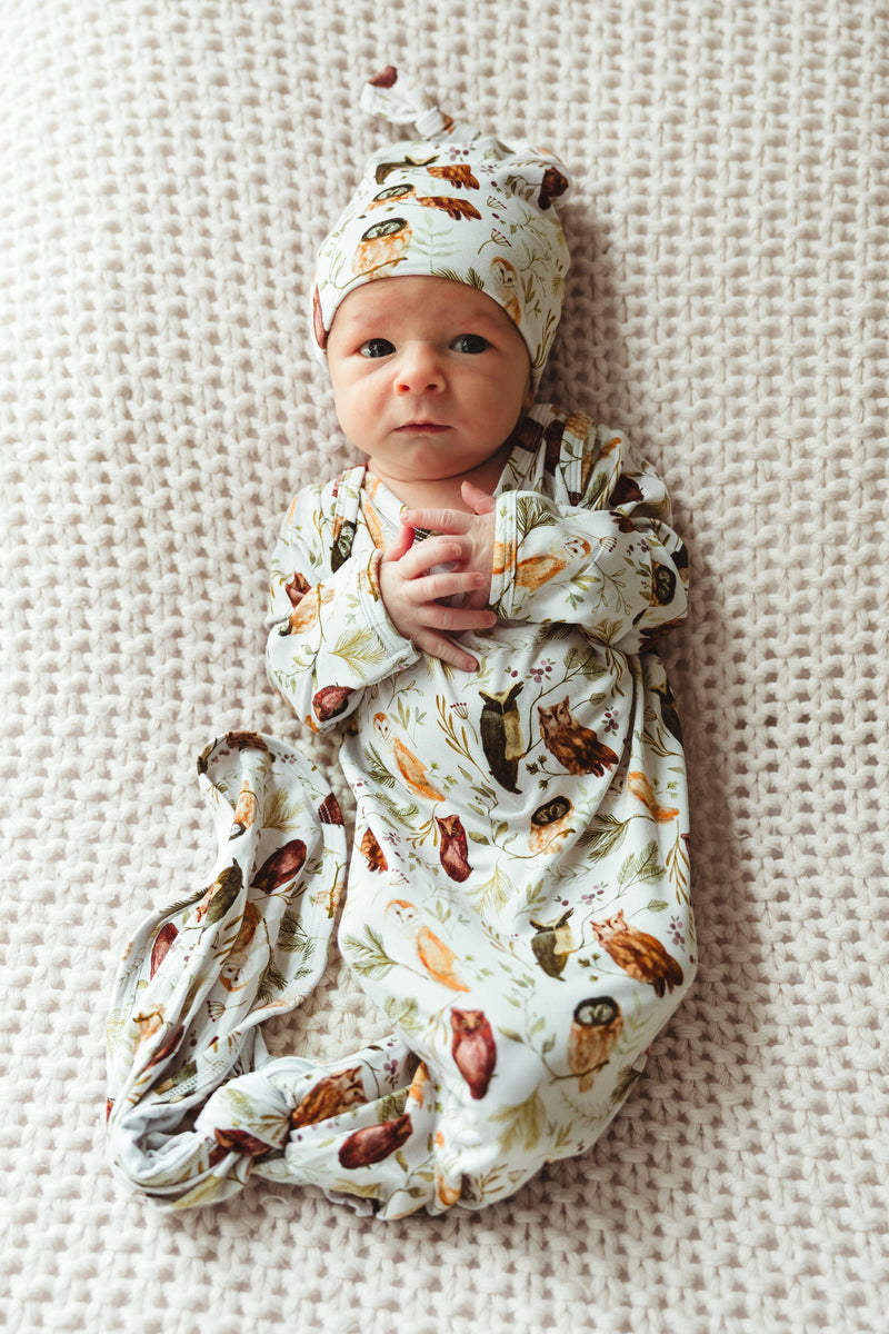 Newborn baby wearing Sleepy Hollow Owls bamboo knotted gown, peacefully lying down in soft, breathable owl print — unisex style ideal for gifting and everyday wear.