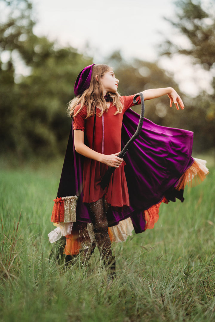 Kids twirling in Hocus Pocus Halloween witch costumes – purple and red Sanderson sisters capes