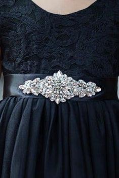 Black tulle and lace flower girl dress photographed in natural outdoor light.
