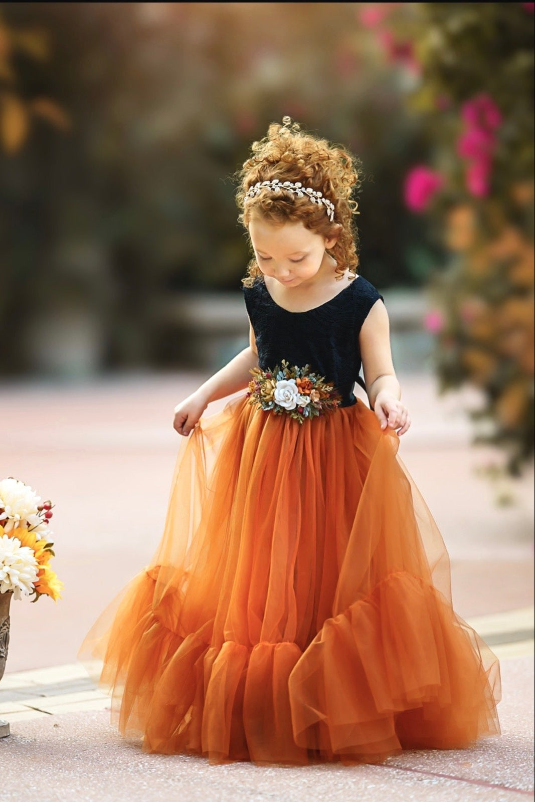 Black lace bodice flower girl dress with burnt orange tulle skirt photographed in natural light