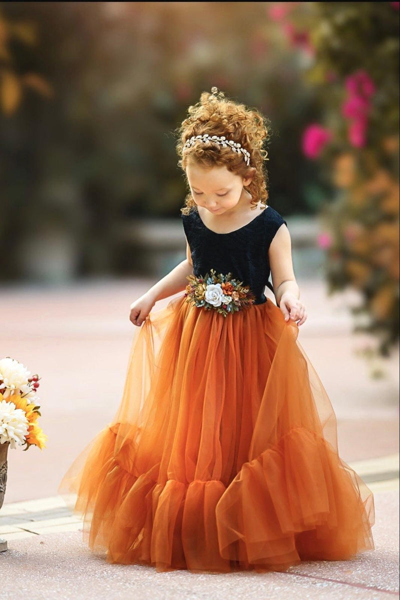 Black lace bodice flower girl dress with burnt orange tulle skirt photographed in natural light