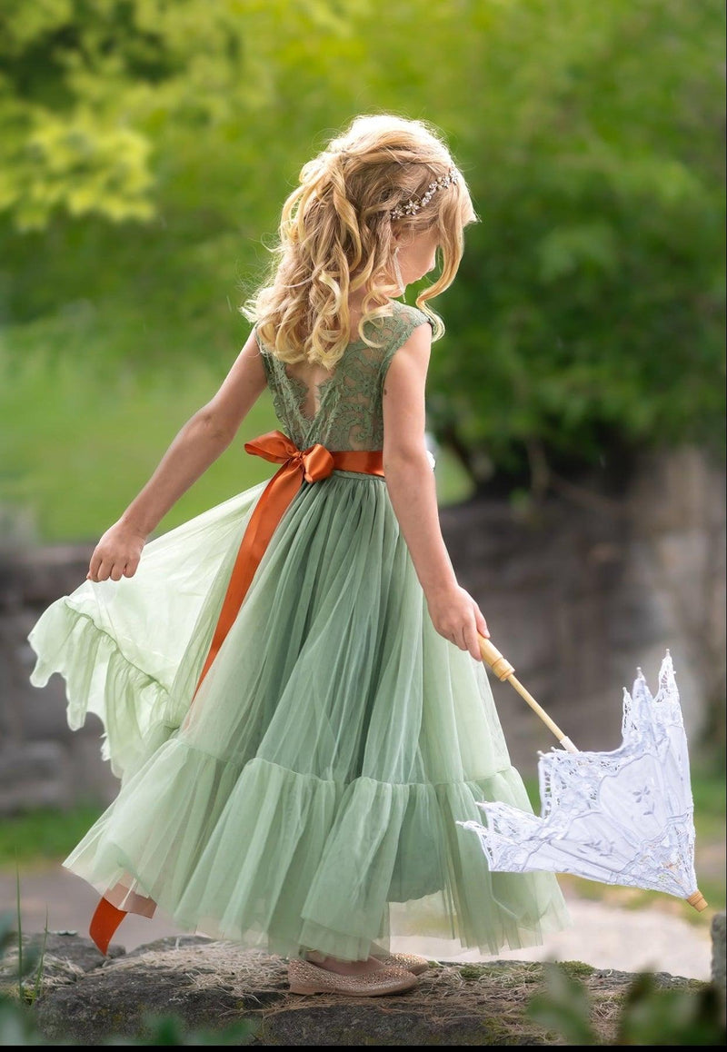 Sage green lace flower girl dress with V-back and layered tulle skirt photographed outdoors