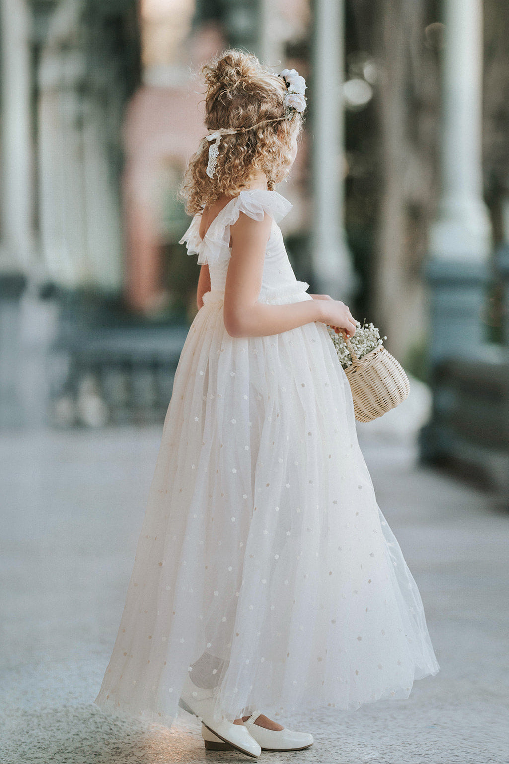 Ivory fleur flower girl dress with flowing embroidered tulle skirt and ruffle sleeves, twirling ivory wedding flower girl dress