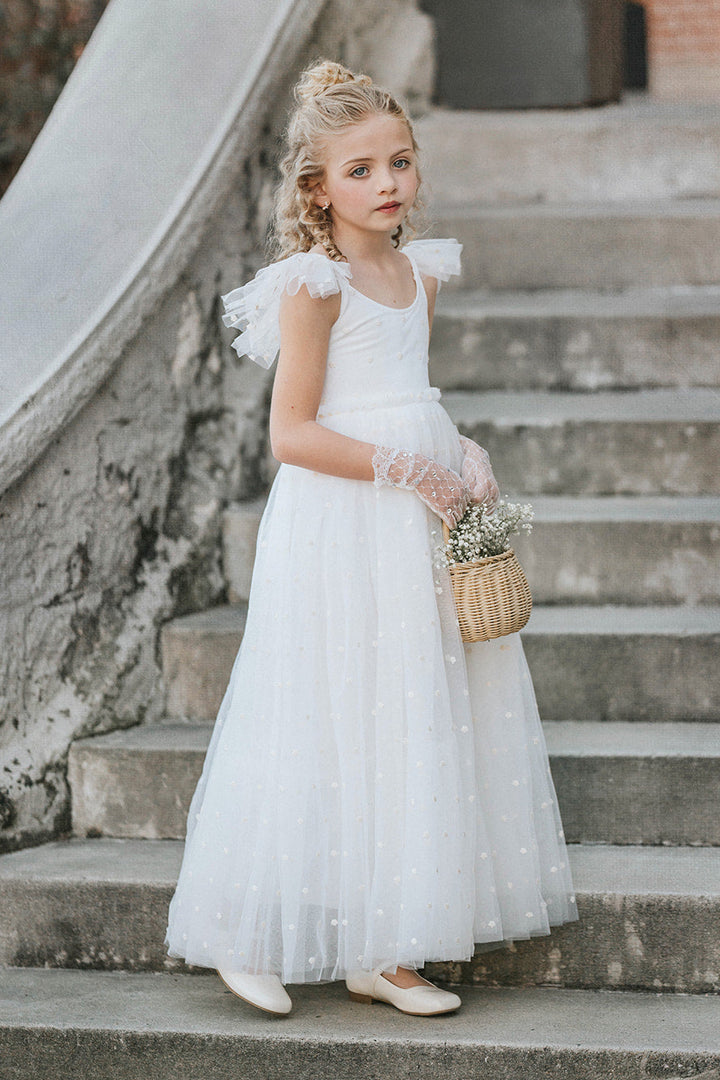Elegant soft white flower girl dress with delicate embroidered floral tulle and flowing skirt, timeless wedding ceremony dress for girls